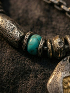 Close-up of natural blue turquoise bead and antique metal spacer rings