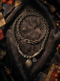 Handcrafted Tibetan vintage necklace with eagle totem pendant and turquoise bead on dark velvet