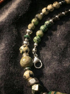 Close-up view of beaded agate strand and silver-tone lobster clasp connection
