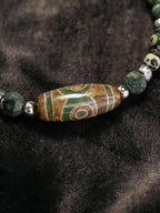 Macro close-up of focal green and brown patterned Tibetan agate Dzi bead